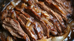 Slow-cooked brisket injected with marinade, sliced and served with caramelized onions and rich sauce